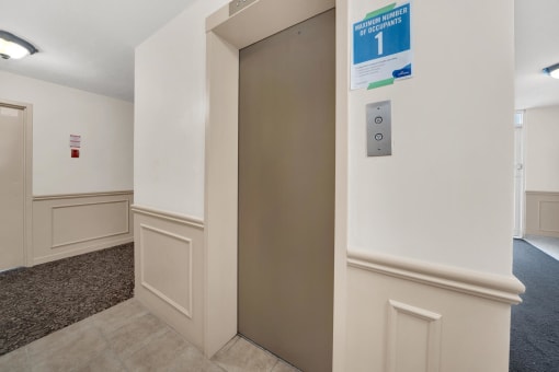 a door in a hallway with a sign above it