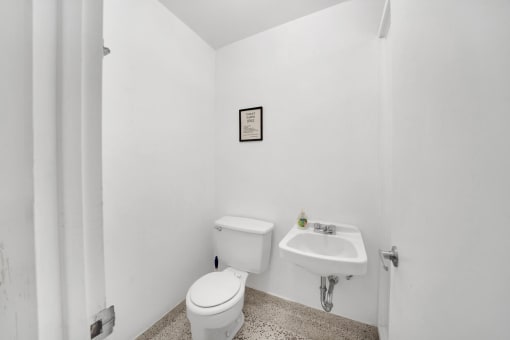a bathroom with a toilet sink and shower in a 555 waverly unit