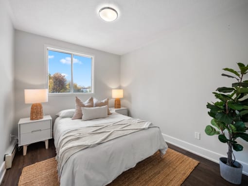 a bedroom with a bed and two night stands
