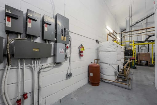 a row of gas meters on a wall with a white wall in the background and a white