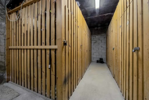 a large room with wooden walls and a white brick wall in the background