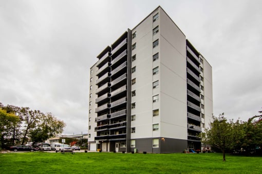 a large white building with a green lawn in front of it