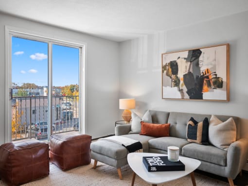 a living room with a large window and a balcony