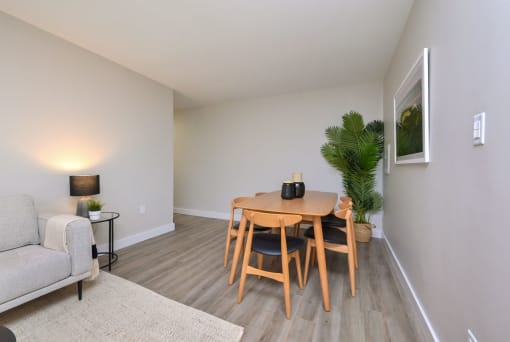 a dining room with a wooden table and chairs