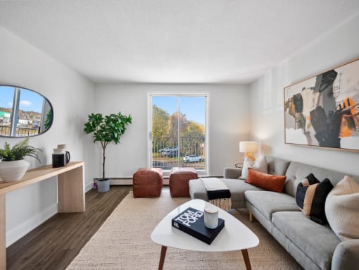 a living room with a large sliding glass door and a view of the parking lot