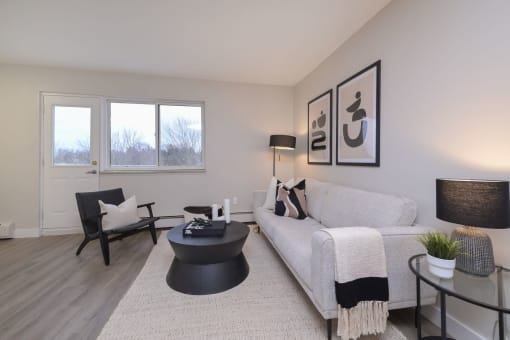 a living room with a white couch and a black coffee table