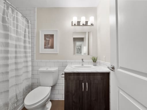 a bathroom with a toilet sink and shower