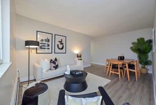 a living room with a couch a table and a lamp