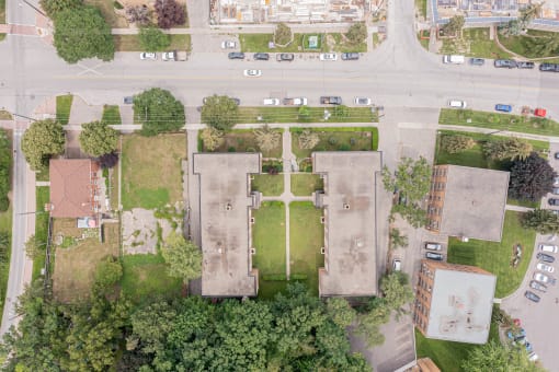 arial view of a campus with cars parked on the side of the road