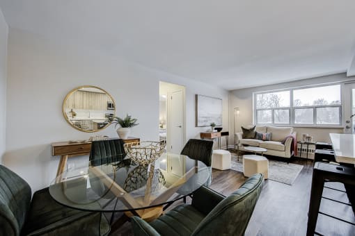 a living room and dining room with a glass table and chairs