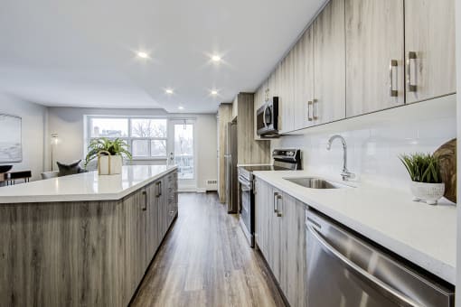 a kitchen with white countertops and wooden cabinets