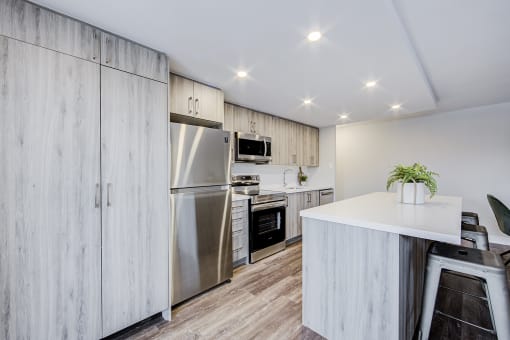 a kitchen with white cabinetry and stainless steel appliances