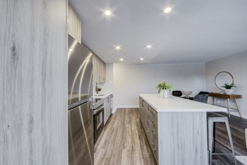 a kitchen with a large island and stainless steel appliances