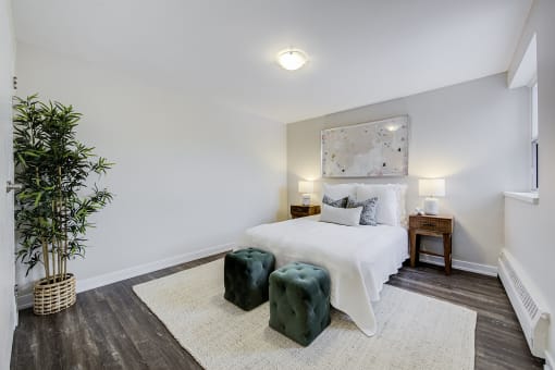 a bedroom with a bed and two end tables