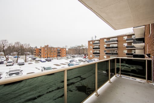 a balcony with a view of a parking lot
