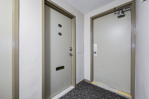 a door to a room with a glass door and a carpeted floor
