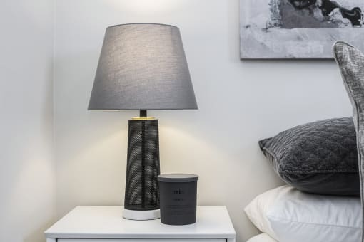 a lamp on a nightstand in a bedroom