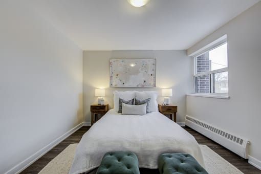 a bedroom with a large bed and a window