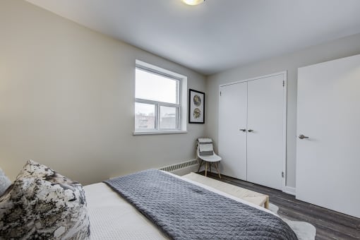 a bedroom with a large bed and a window