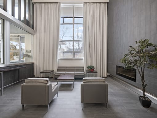 a view of the living room with a large window and a bench in front of it