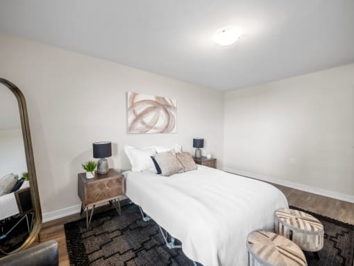 a bedroom with a white bed and a brown rug