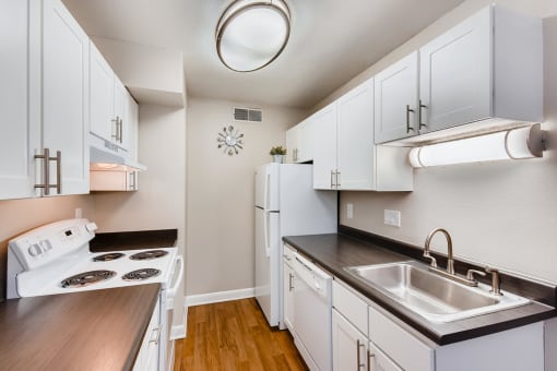 a kitchen with white cabinets and white appliances