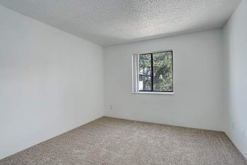 the living room of an apartment with a window