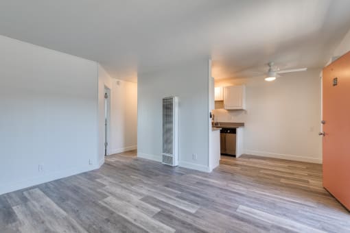 a bedroom with hardwood flooring and white walls