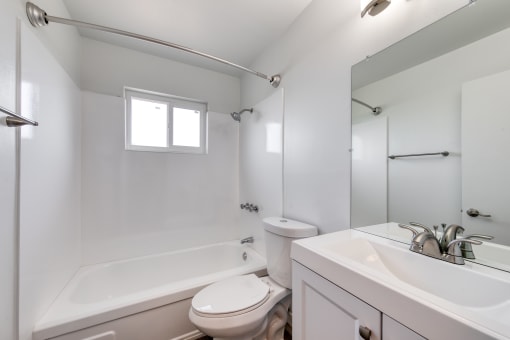 a bathroom with a bathtub toilet and sink