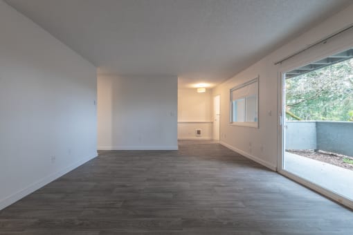 a bedroom with a large window and white walls