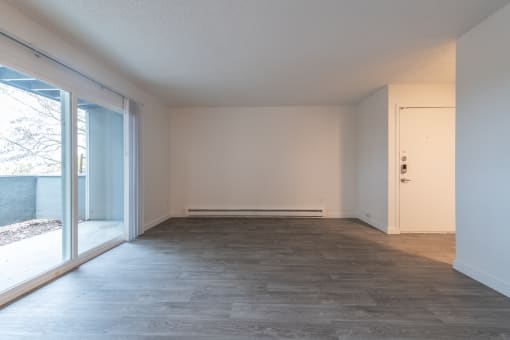 an empty living room in a house with a large sliding glass door