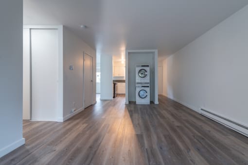 a living room with hardwood floors and white walls