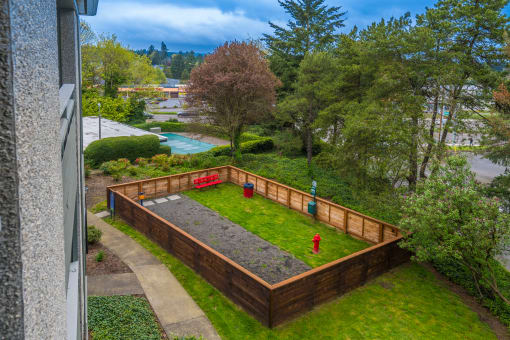 a backyard with a retaining wall and a fire hydrant