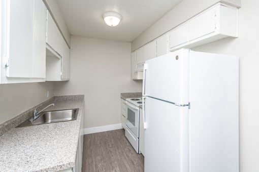 a kitchen with white appliances and white cabinets