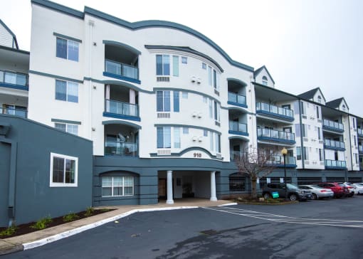 a large white building with cars parked in front of it