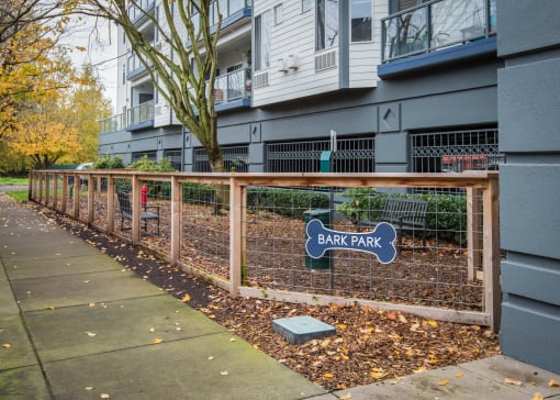 a fence with a sign that says bark park