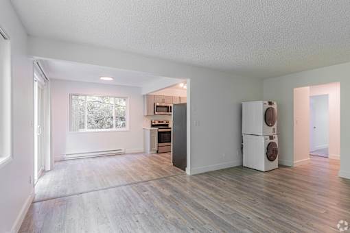 A kitchen area with a refrigerator, oven, and microwave.