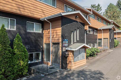 A building with a brown and black exterior and a sign that reads "2412 788".