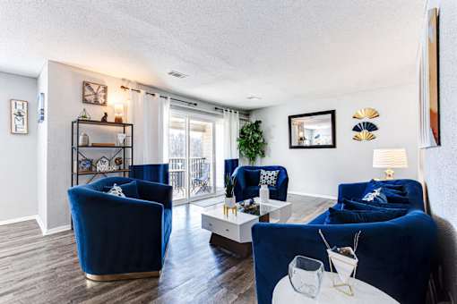 a living room with blue furniture and a sliding glass door