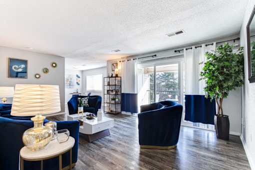 a living room with blue couches and a white coffee table