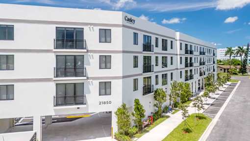 A white apartment building with the number 21850 on the front.