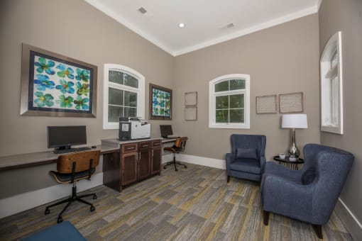a home office with two chairs and a desk with a computer