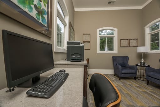 a home office with a computer and a keyboard on a desk