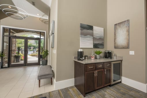 the lobby of a home with a counter and a door to a patio