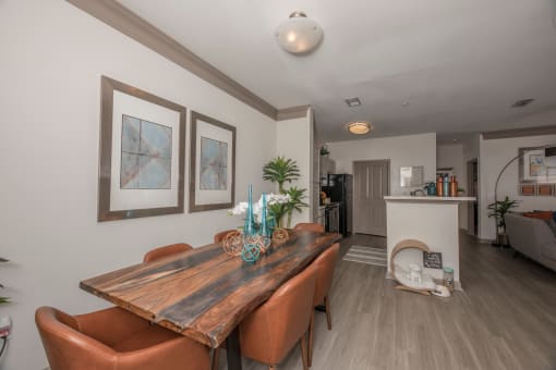 a dining room with a wooden table and leather chairs
