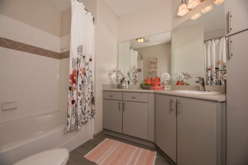 a bathroom with a shower and a sink and a toilet