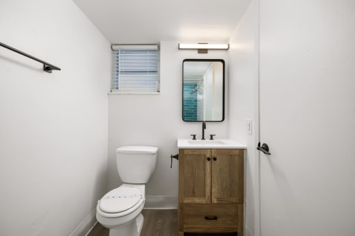a small bathroom with a toilet sink and mirror