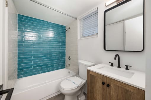 a bathroom with a sink toilet and a bath tub