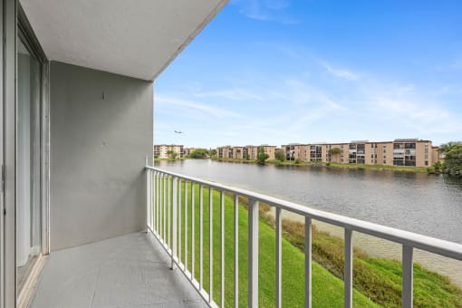 the views of the water from the balcony of an apartment building with a river