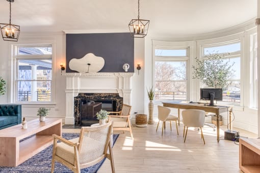 a living room with a fireplace and a large window